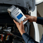 Volvo service technician inspecting a battery